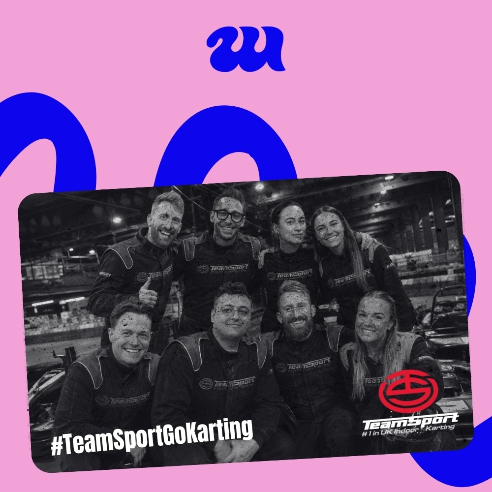 Smiling group in TeamSport go-karting suits after race
